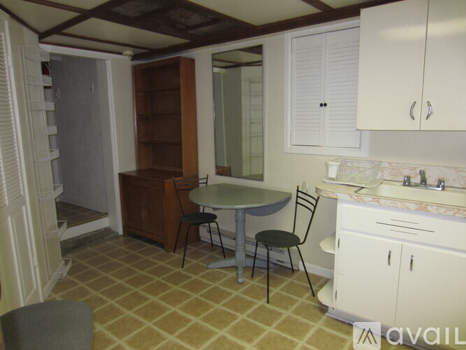 A kitchen with a table and chairs in the middle of the room.