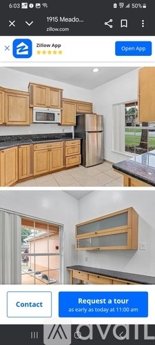 A kitchen with wooden cabinets and a black countertop.