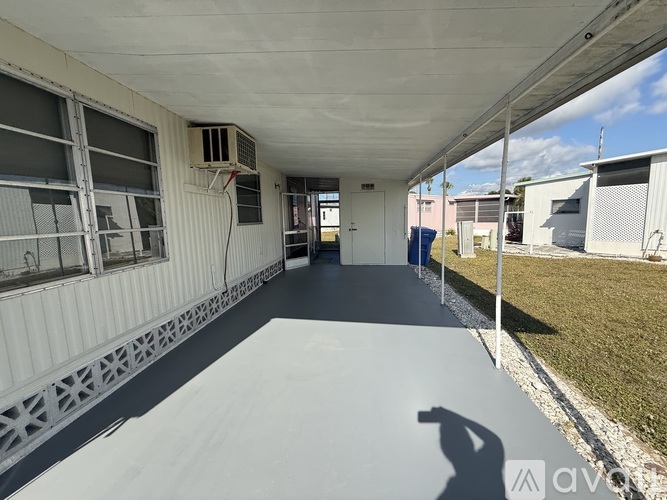 A long, narrow, covered walkway with a metal grate on the floor.