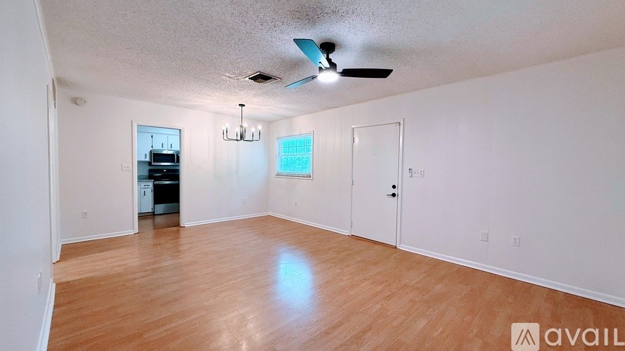 A room with a ceiling fan and a chandelier.