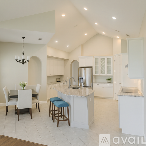 A modern kitchen with a dining table and chairs.