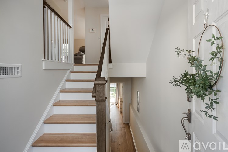 A staircase with wooden steps and a metal railing.