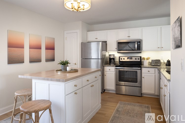 A kitchen with white cabinets and stainless steel appliances.
