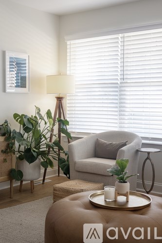 A living room with a couch, chair, and a table with a tray on it.