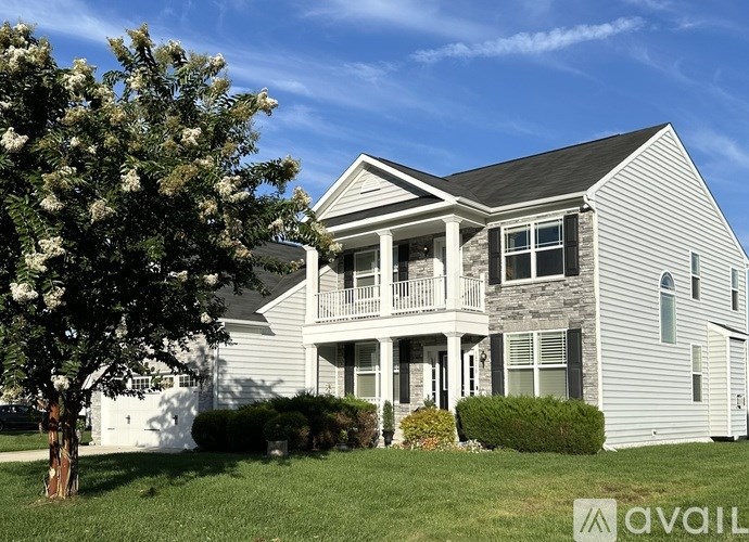 A house with a tree in front of it.