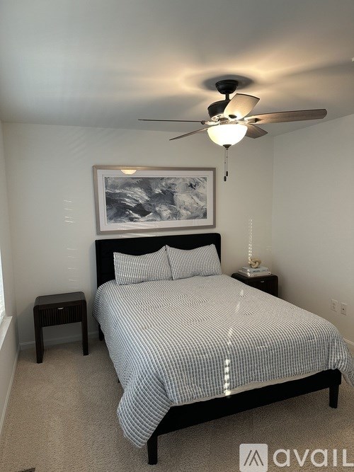 A bathroom with a toilet, sink, and shower curtain.