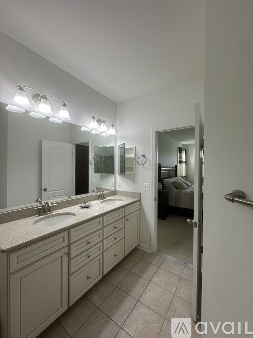A bathroom with a vanity and a mirror.