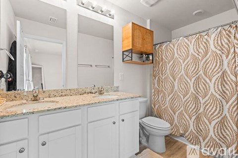 A bathroom with a sink, toilet, and shower.