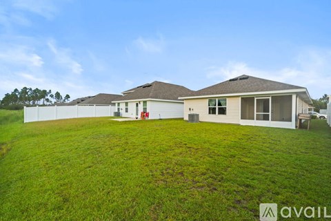 A house with a large lawn is for sale.