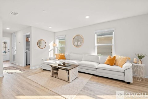 A living room with a white couch and a coffee table.