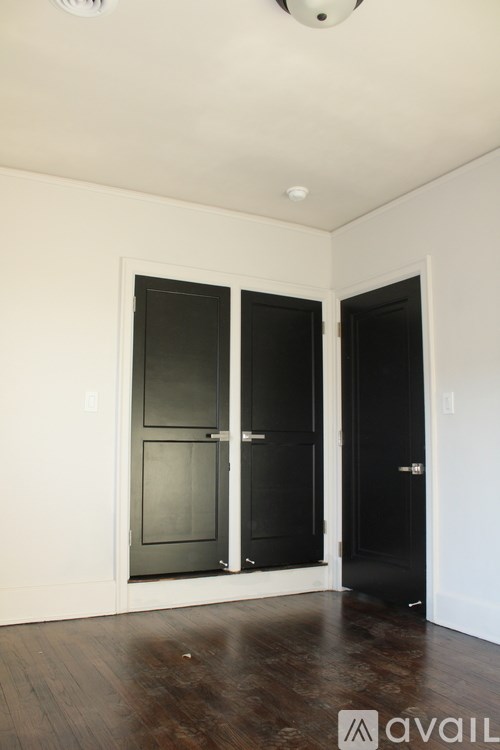 A room with a black door and a white door.