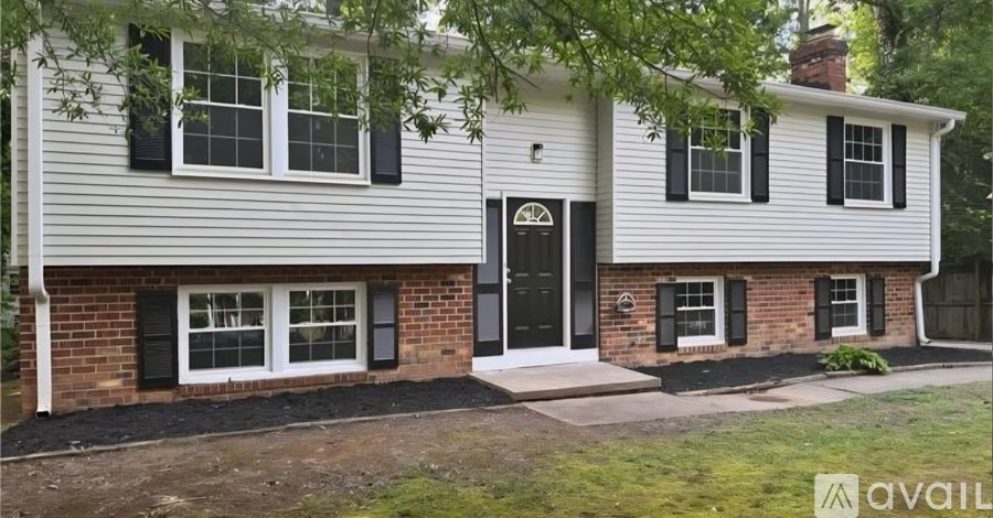 A house with a black front door and windows.