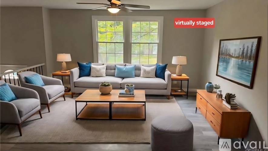 A living room with a couch, chairs, and a coffee table.