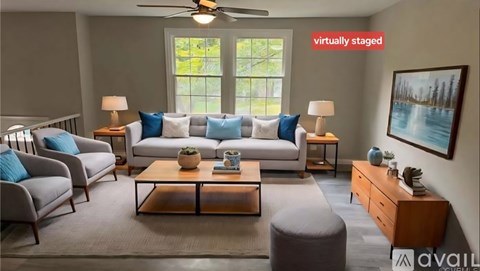 A living room with a couch, chairs, and a coffee table.