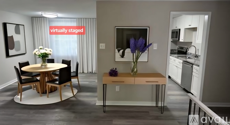 A modern dining room with a round table and chairs.