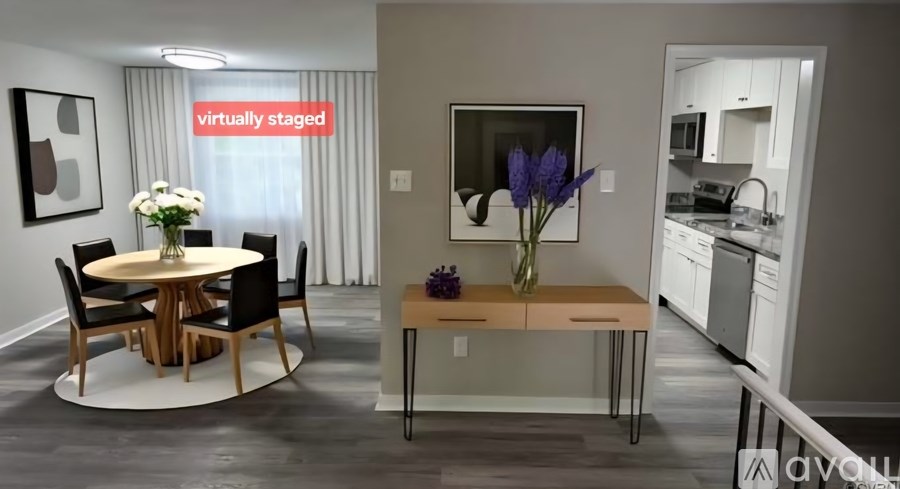 A modern dining room with a round table and chairs.