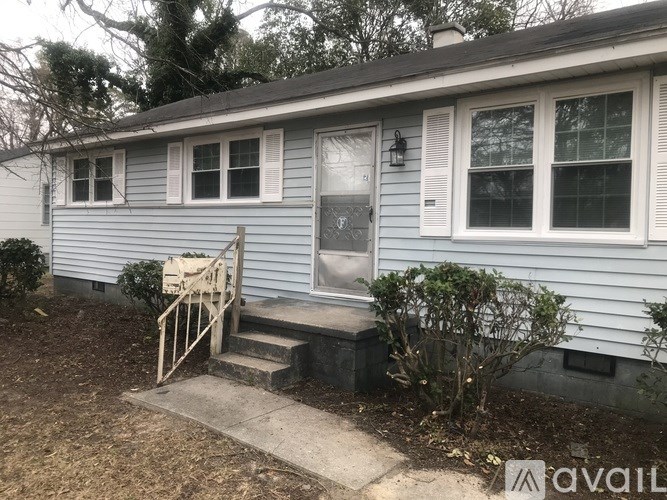 A house with a blue siding and a white door.