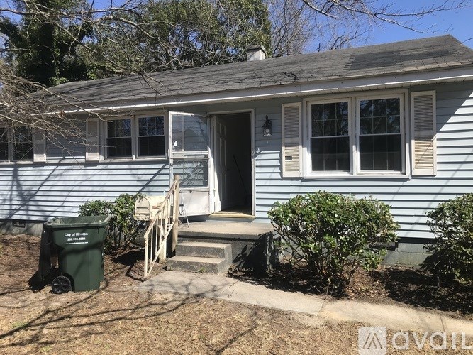 A house with a blue siding and a white door.