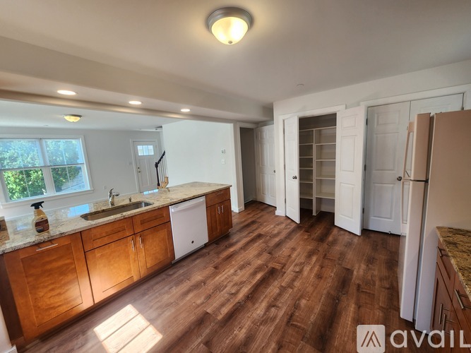 A kitchen with wooden floors and a central island with a countertop.