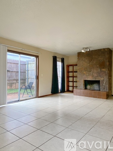 A living room with a fireplace and sliding glass doors.