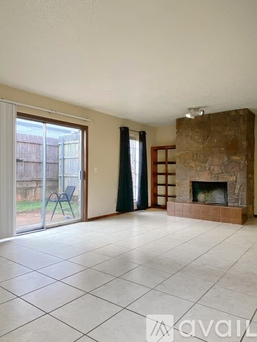 A living room with a fireplace and sliding glass doors.