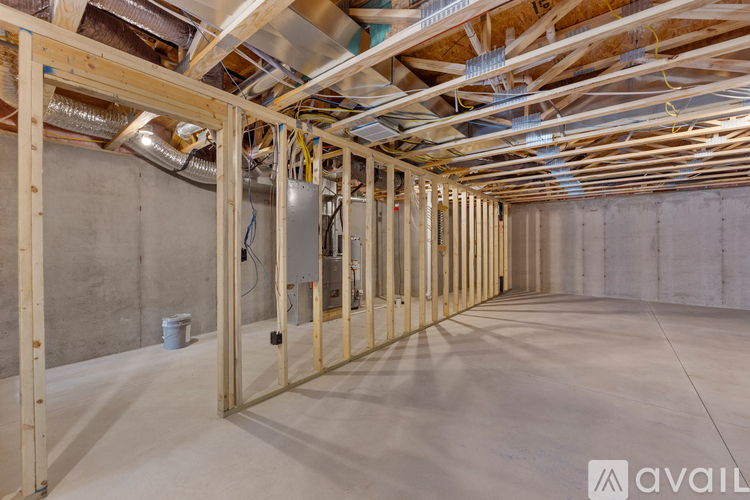 A room under construction with wooden beams and insulation.