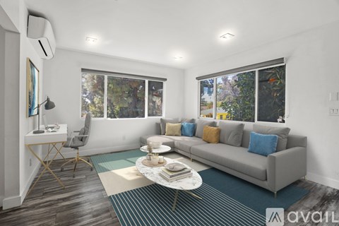 A living room with a grey couch and a coffee table.