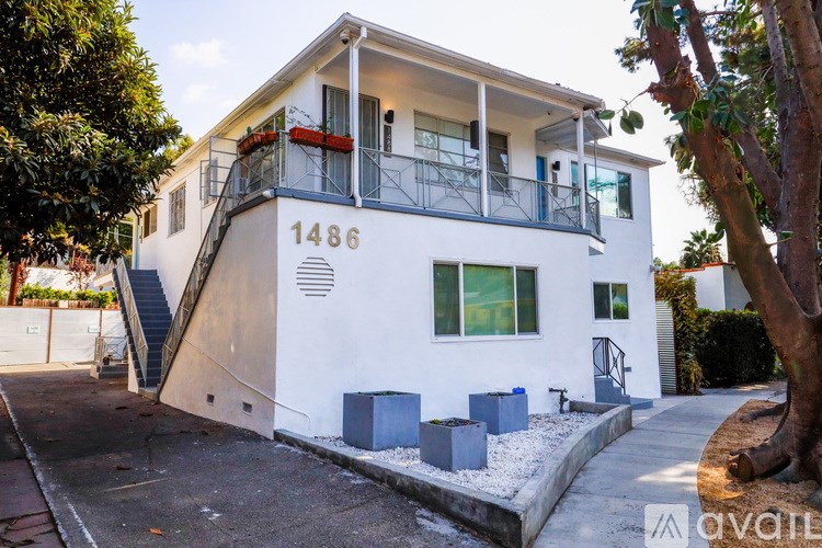 A white two-story house with the number 1486 on the front.