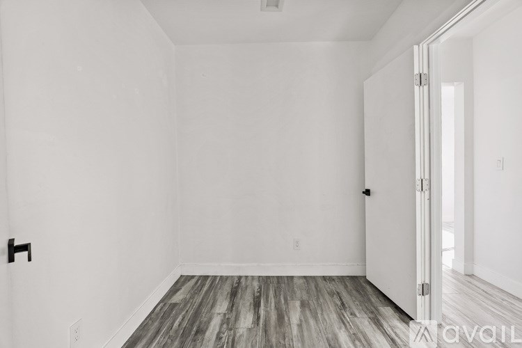 A room with a wooden floor and white walls.