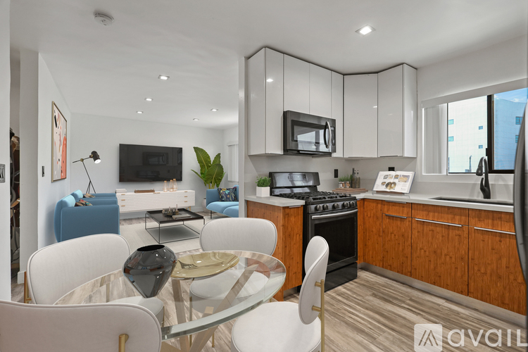 A modern kitchen with a dining table and chairs.