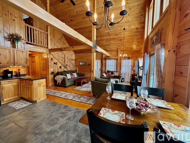 A wooden cabin with a dining table set for a meal.