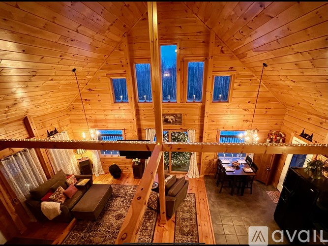 A cozy wooden cabin with a living area and a balcony.