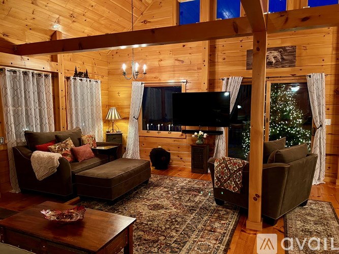 A cozy living room with a couch, coffee table, and a television.