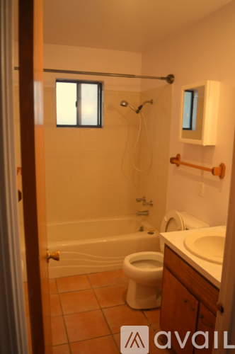 A bathroom with a toilet, sink, and bathtub.