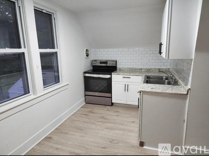 A kitchen with a stove, oven, and sink.