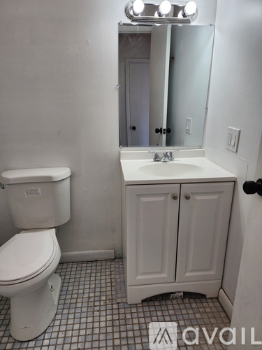 A white toilet sits next to a sink in a bathroom.