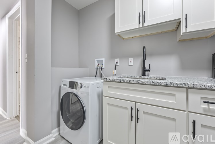 A washing machine is placed in a kitchen.
