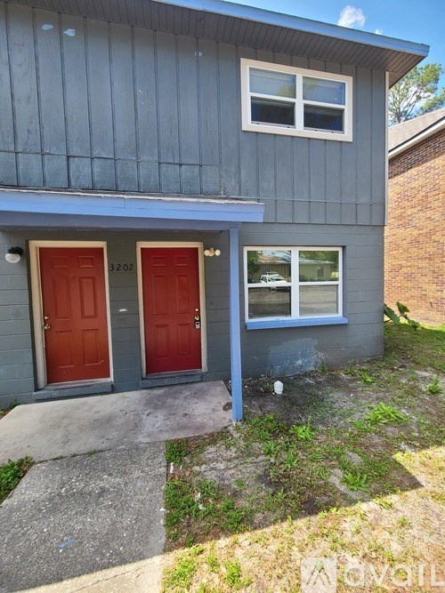 A house with a red door and a window.