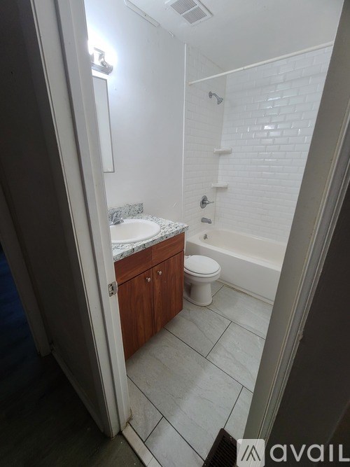 A bathroom with a toilet, sink, and bathtub.