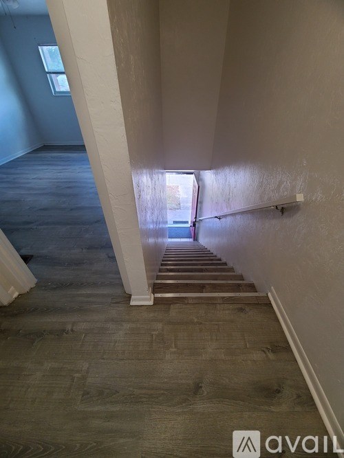A room with a wooden floor and a white door.