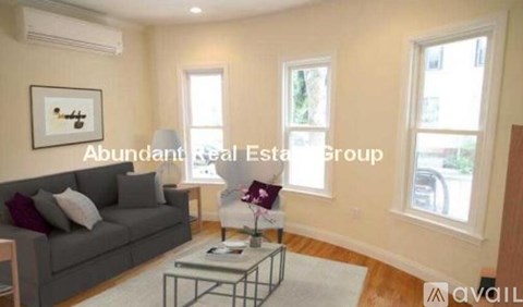 A living room with a grey couch and a coffee table.