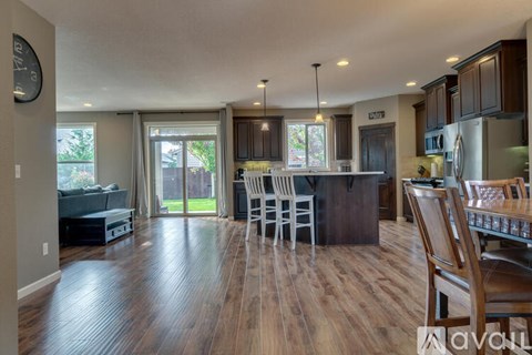 A modern kitchen with dark wood floors and a center island.