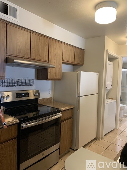 A kitchen with a stove, oven, and refrigerator.