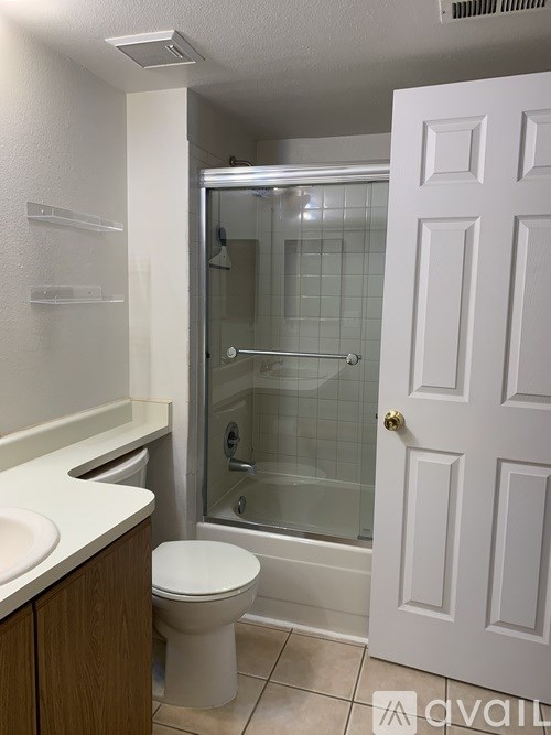 A white toilet sits next to a sink in a bathroom.