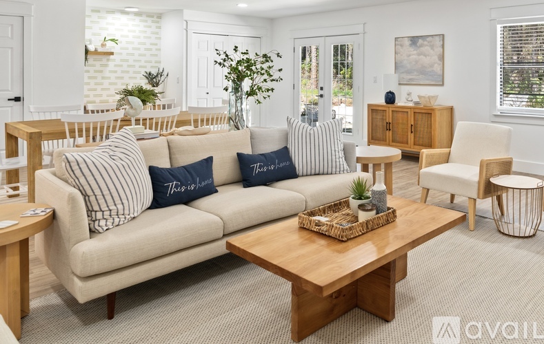A living room with a sofa, armchair, and coffee table.