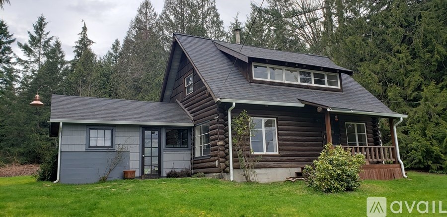 A small wooden cabin with a porch and a sign that says "available".