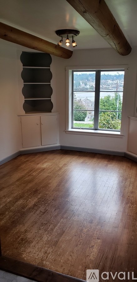 A room with wooden floors and a window.