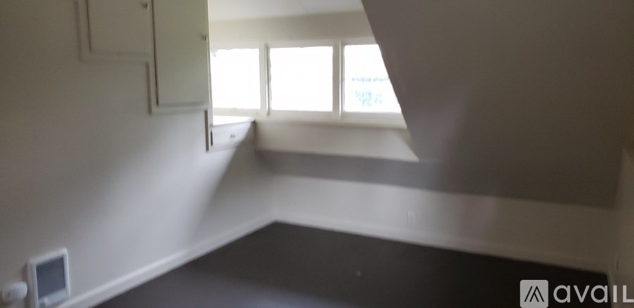 A room with a window and a wall-mounted monitor.