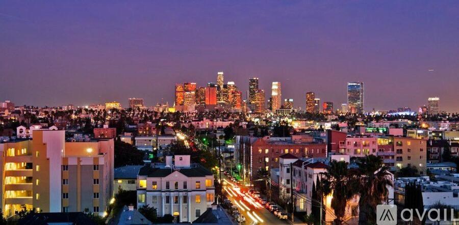 A cityscape at dusk with the skyline illuminated.