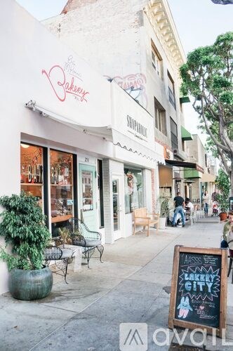 A street view of a shopping area with a sign that says "Lake City".
